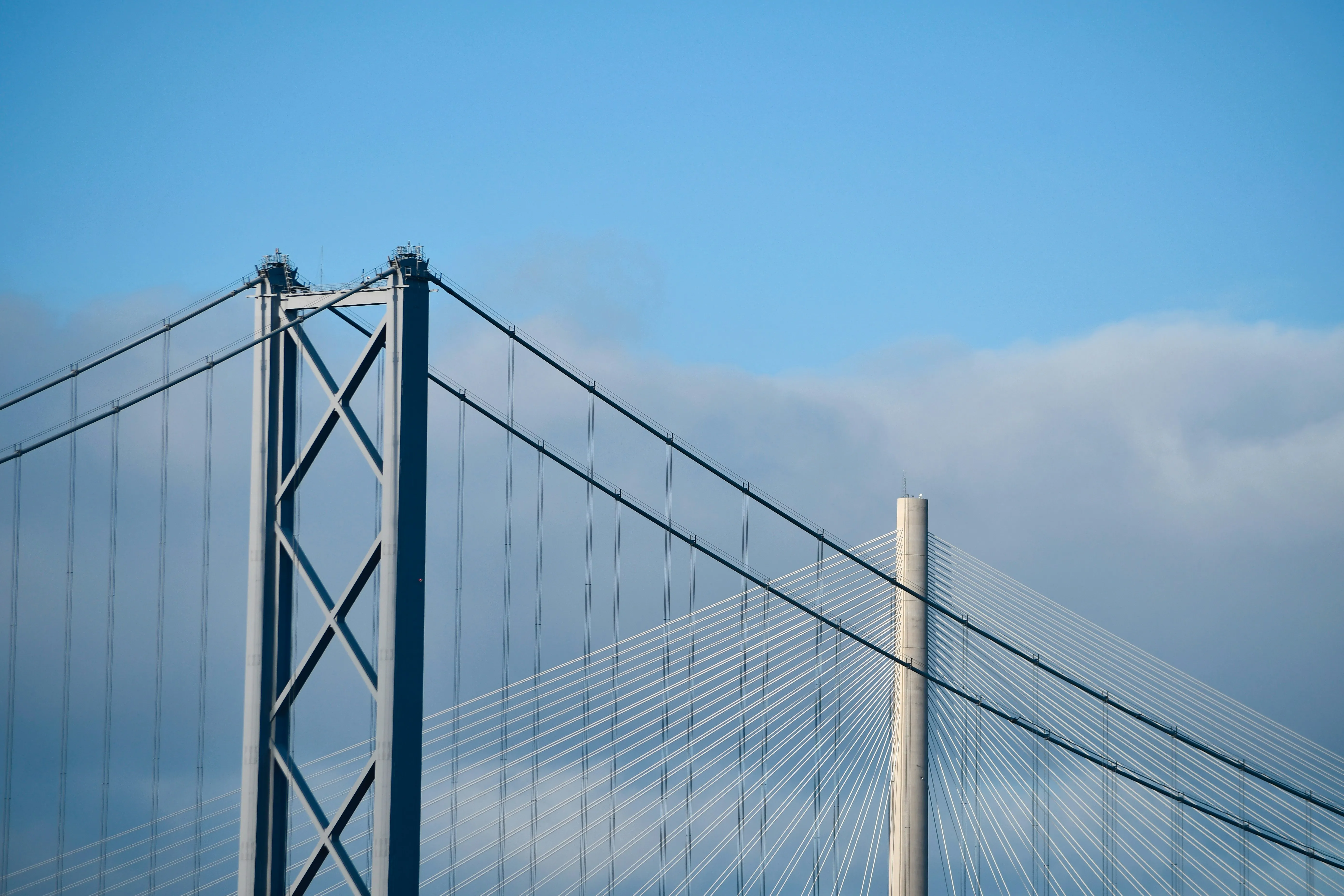The towers and cables of the Forth Road Bridge and Queensferry Crossing