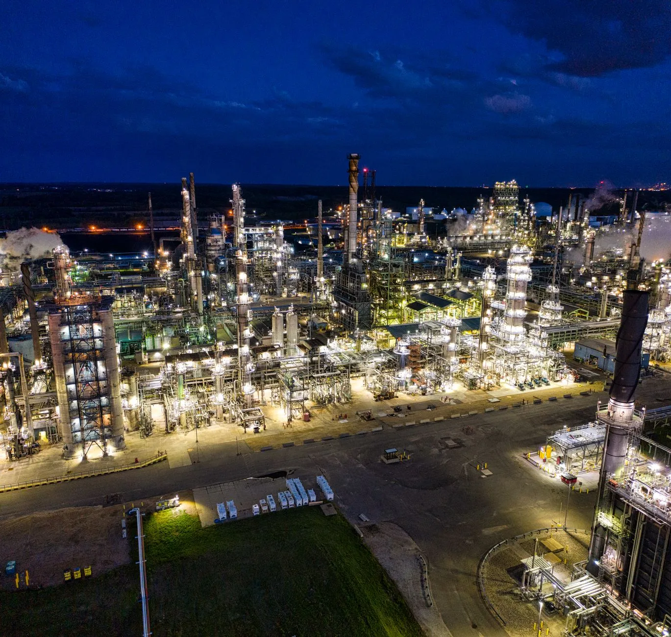 An illuminated industrial plant at night