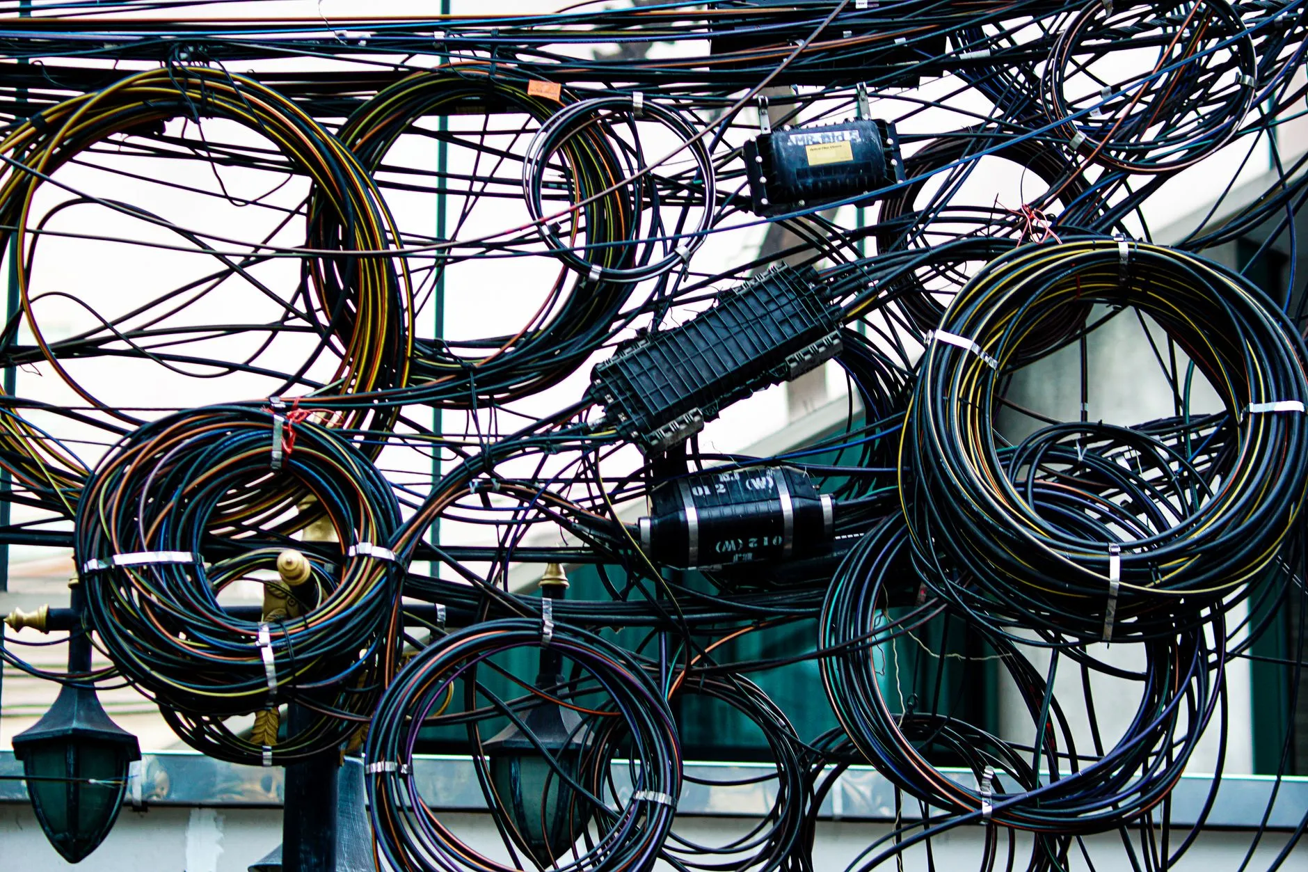 A dense tangle of network cables and wiring